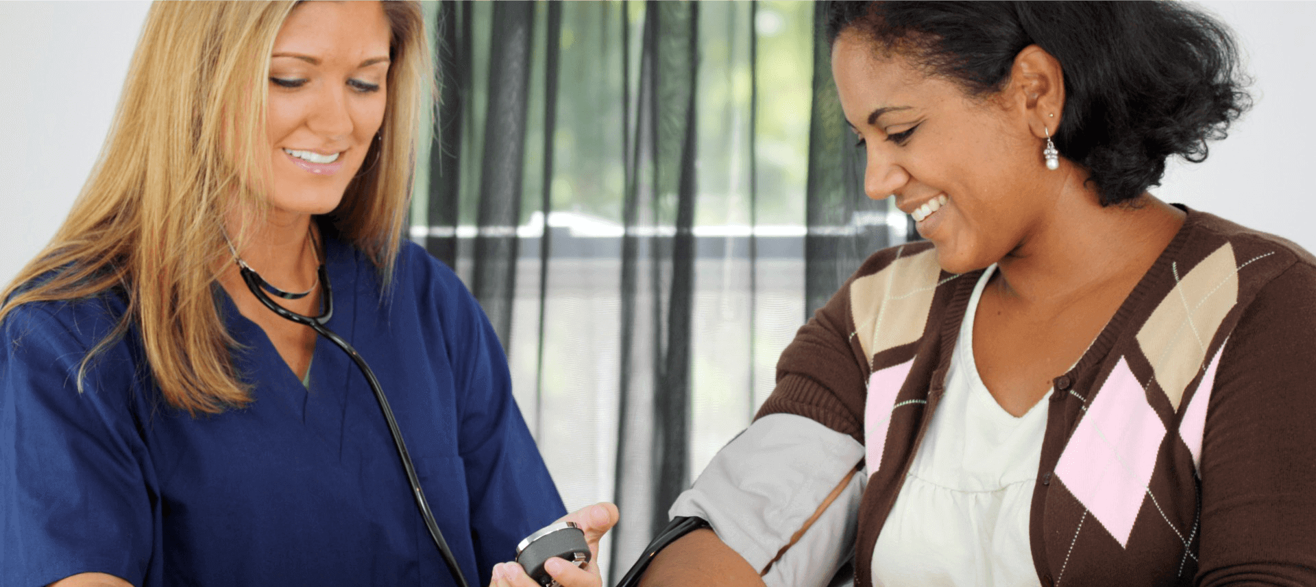 nurse checking patient's blood pressure