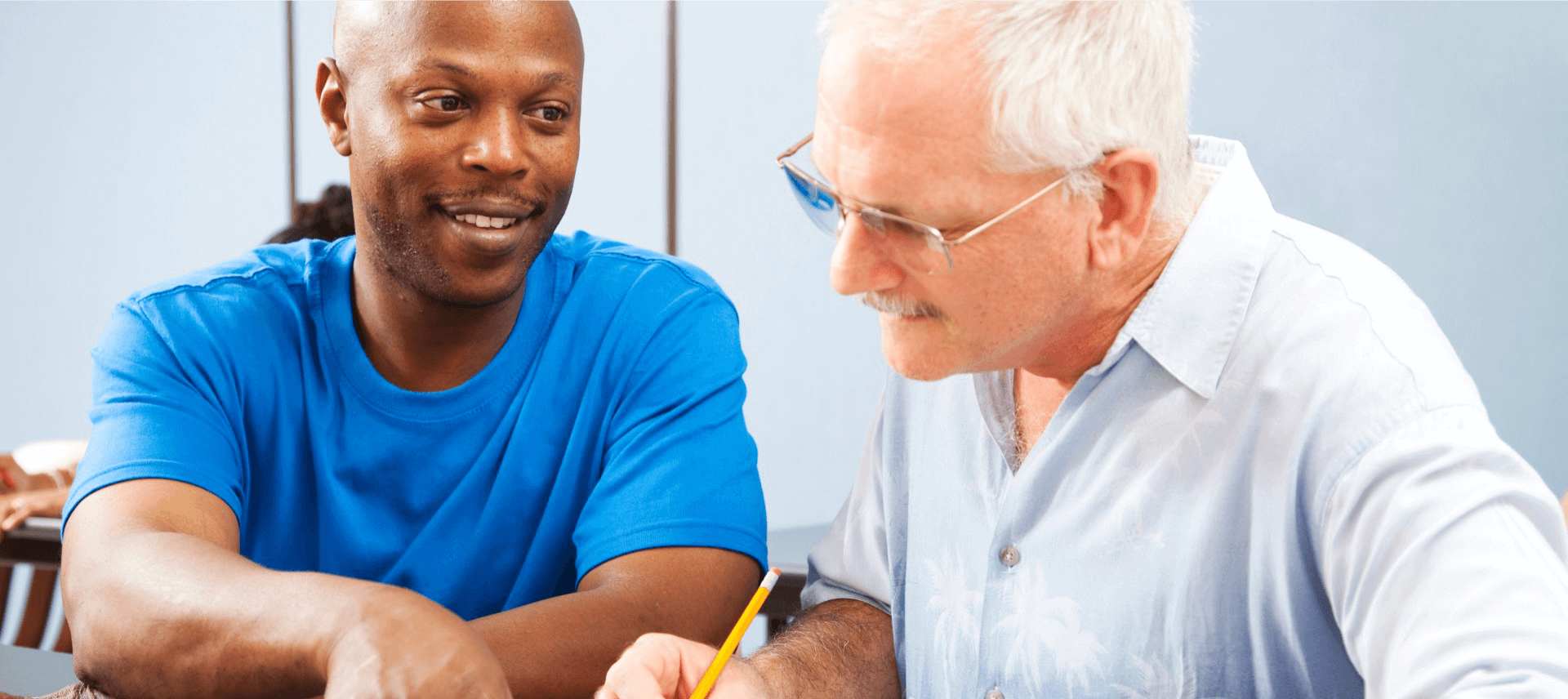 caregiver assisting patient to write